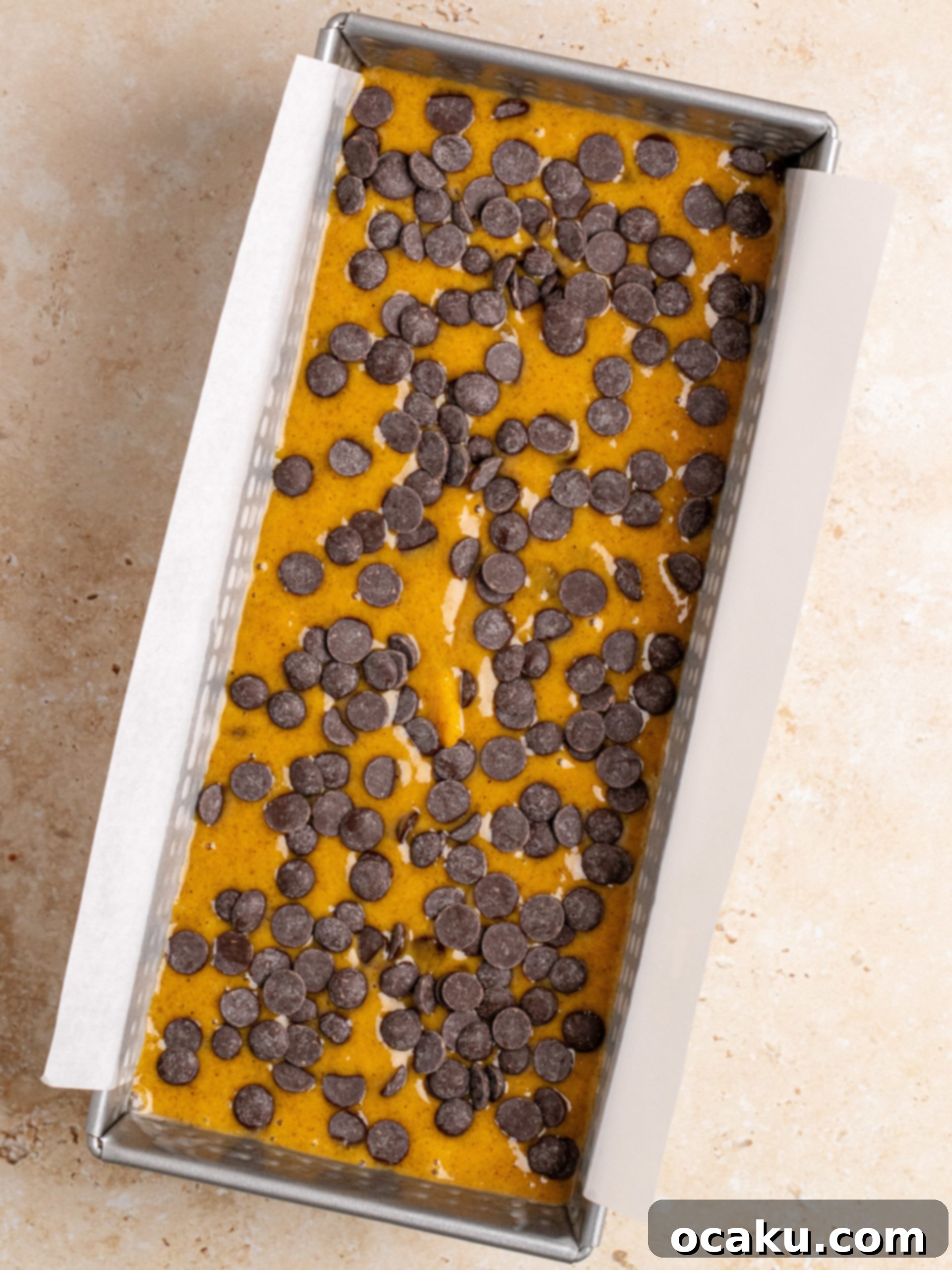 Baked pumpkin chocolate chip bread cooling on a wire rack.