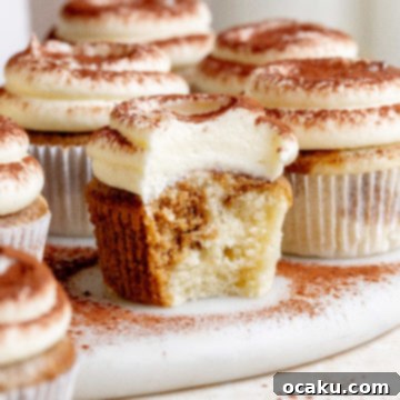 Beautifully decorated Tiramisu Cupcakes with mascarpone frosting and cocoa powder.
