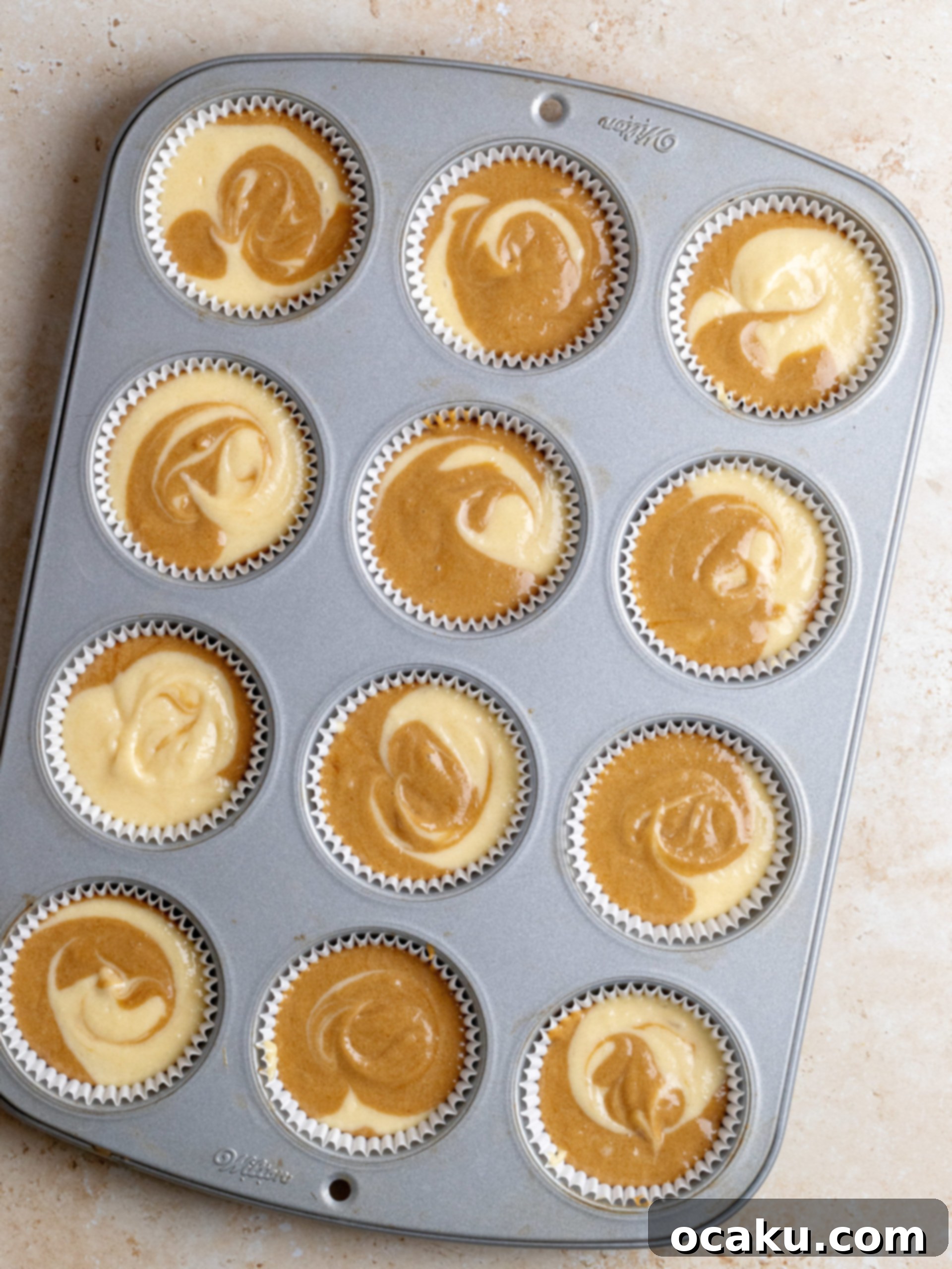 Mascarpone buttercream being piped onto a tiramisu cupcake.