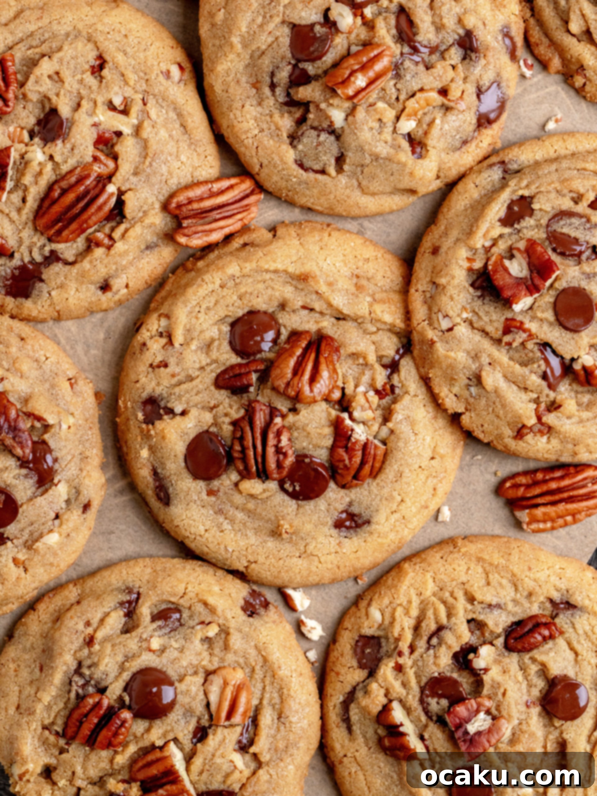 Decadent Chocolate Pecan Cookies 2 Close-up of a stack of large, golden-brown chocolate chip pecan cookies on a white plate.