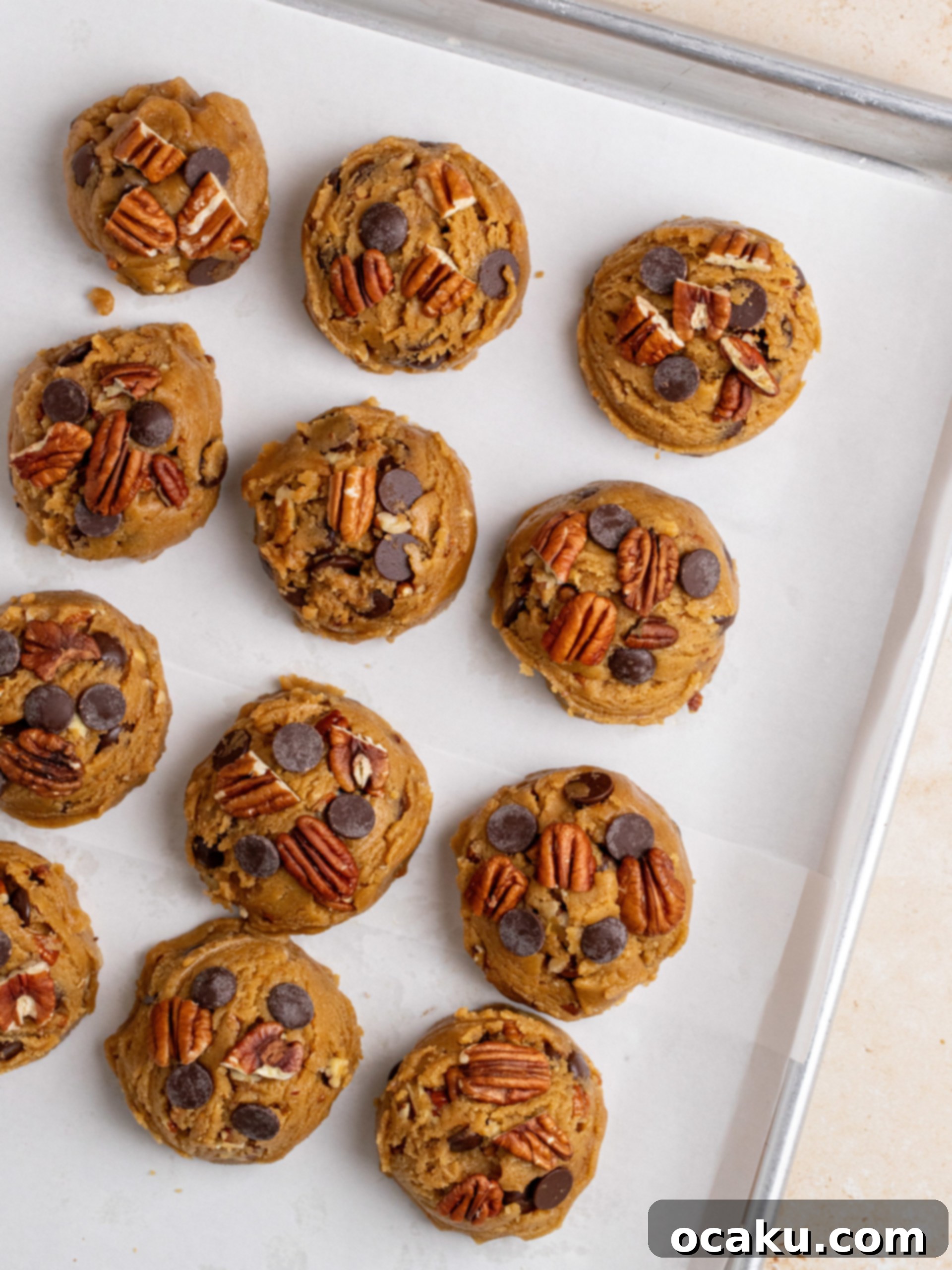 Decadent Chocolate Pecan Cookies 7 A baking tray with chocolate chip pecan cookie dough balls chilling.