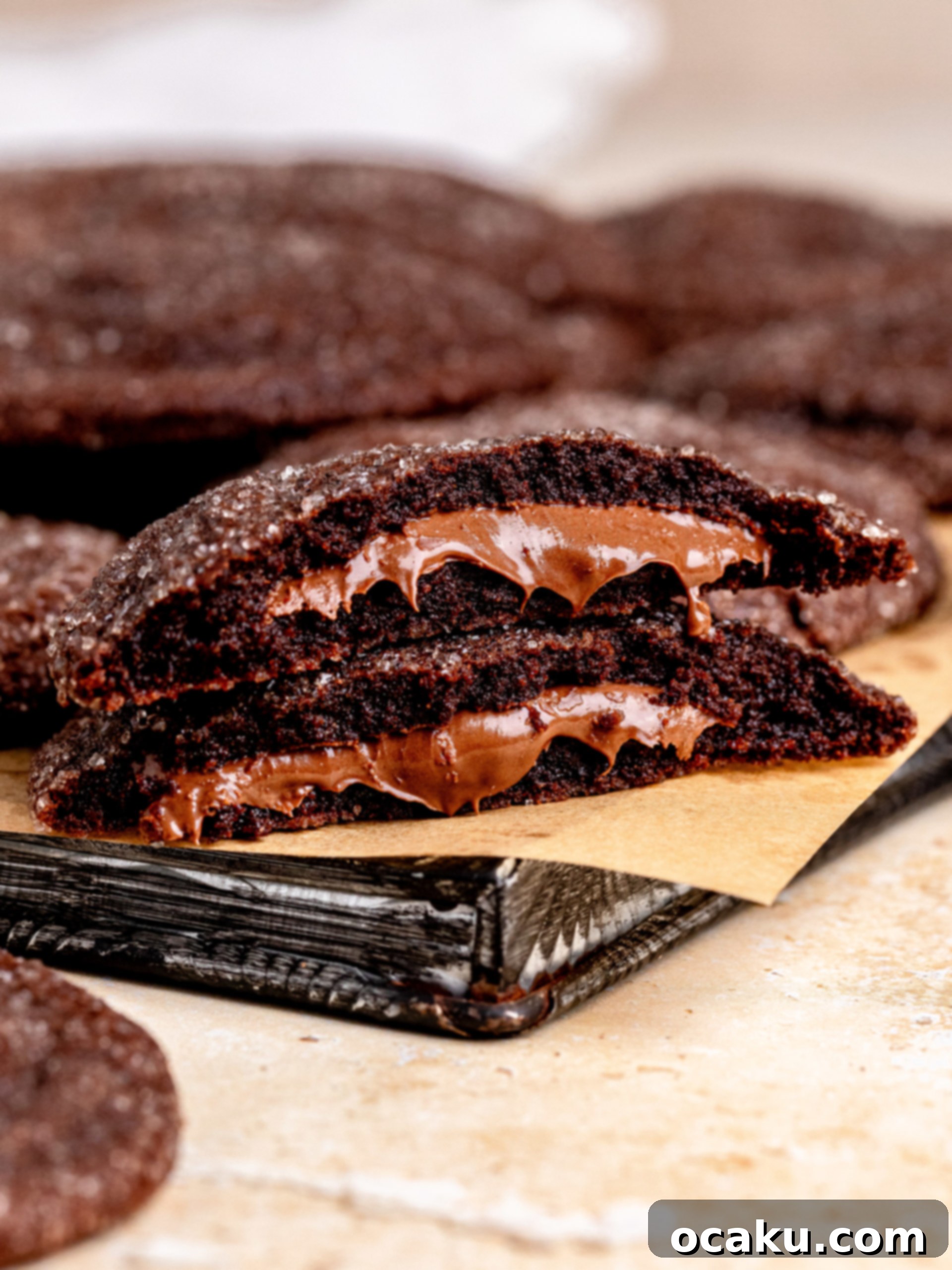Freshly baked large Nutella Stuffed Cookies on a cooling rack, showcasing their rich chocolate color and slightly cracked tops.