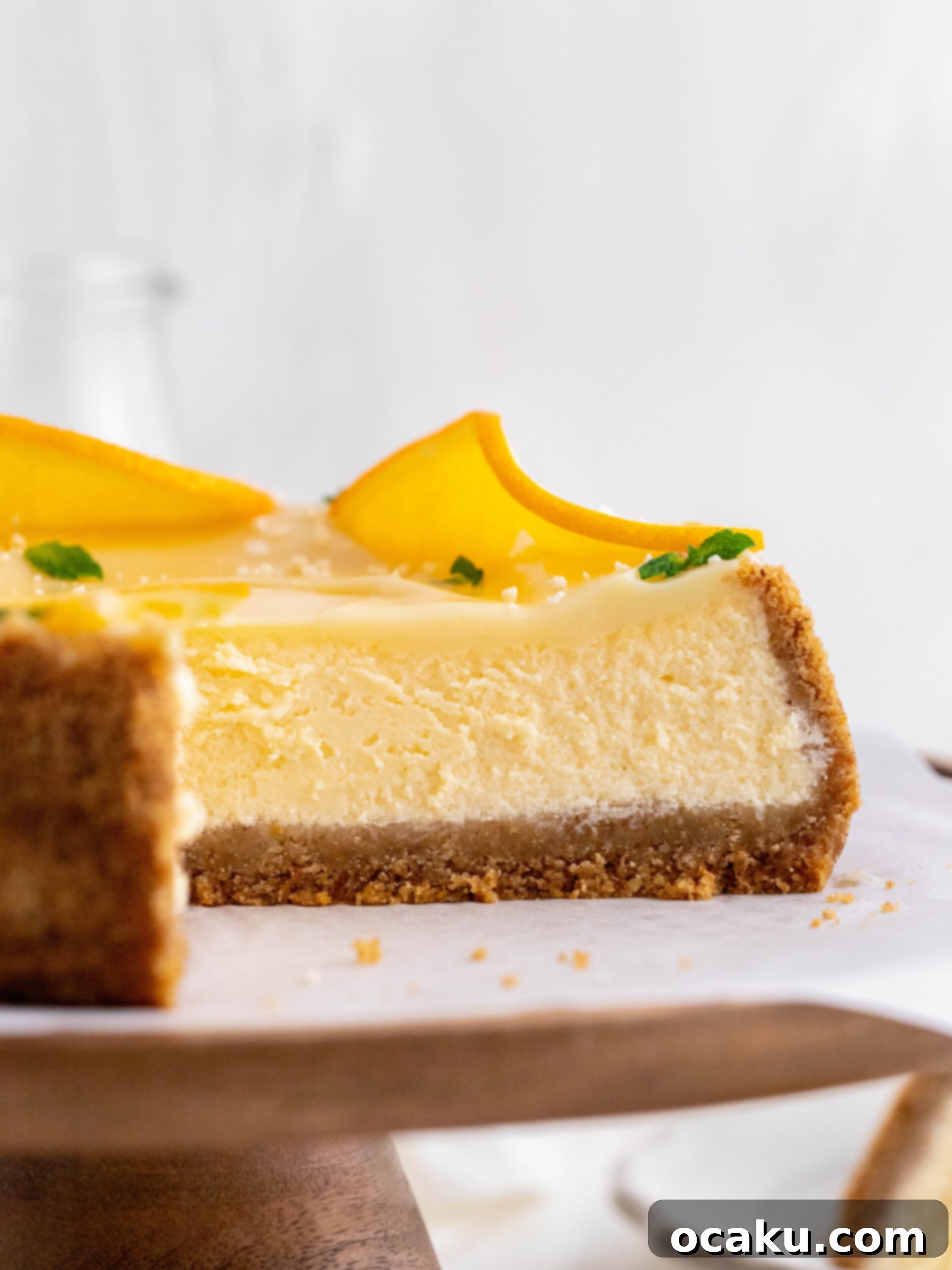 Spritz Sunset Cheesecake 5 A freshly baked cheesecake cooling on a rack, still in its springform pan.