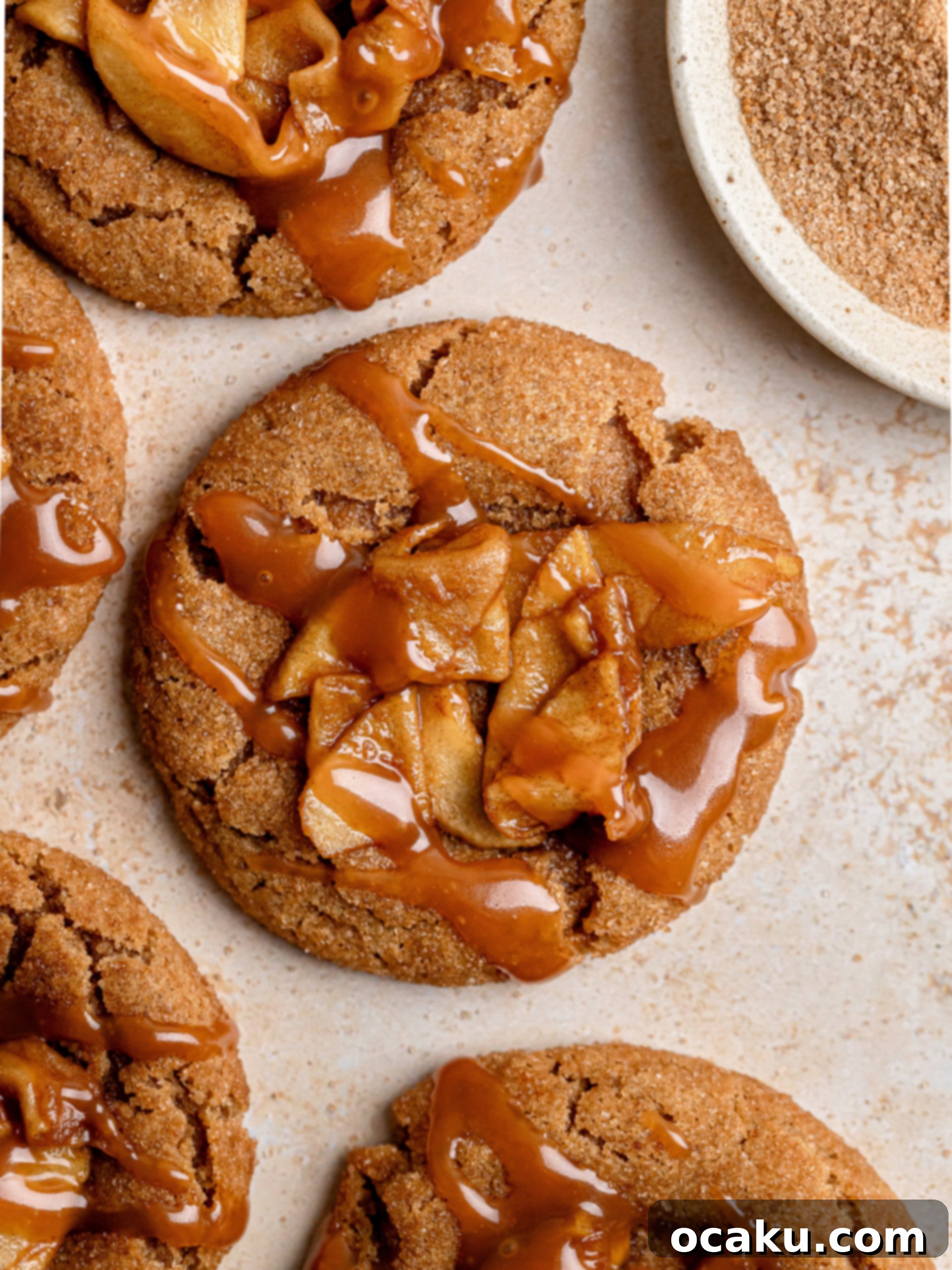 Close-up of baked Apple Pie Cookies with apple filling and caramel drizzle.