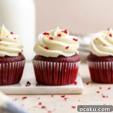 A top-down view of a classic red velvet cupcake with cream cheese frosting