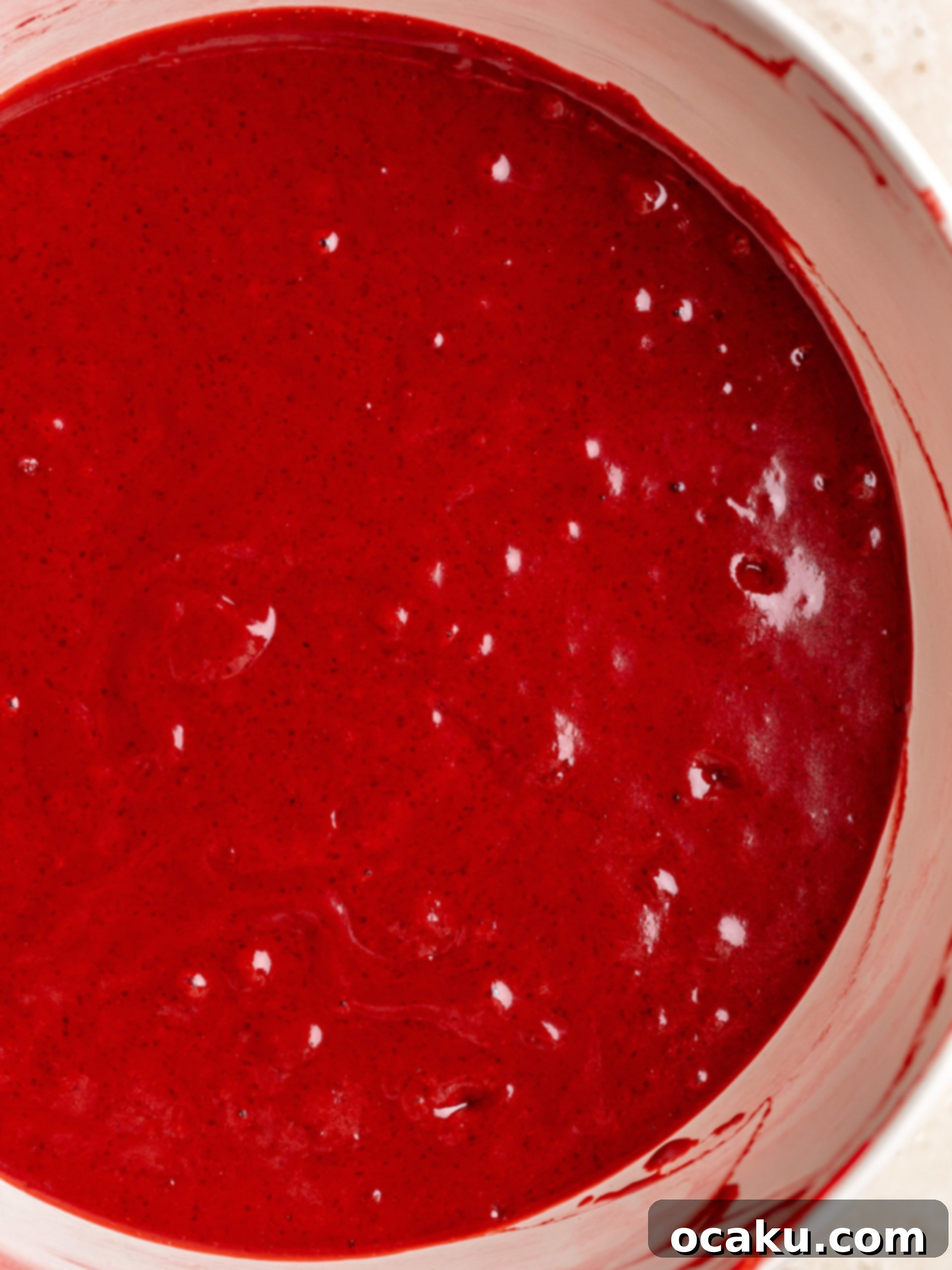 Mixing wet and dry ingredients for red velvet cupcake batter